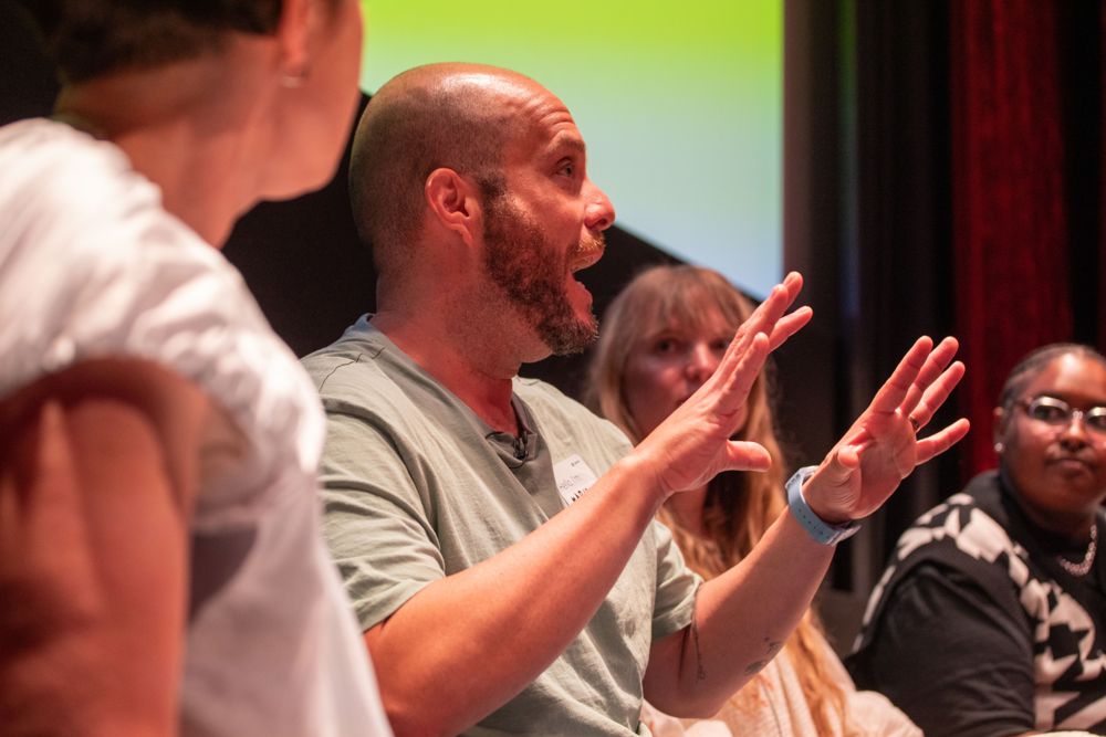 Mario mid-gesture in an animated conversation at Lead With Tempo