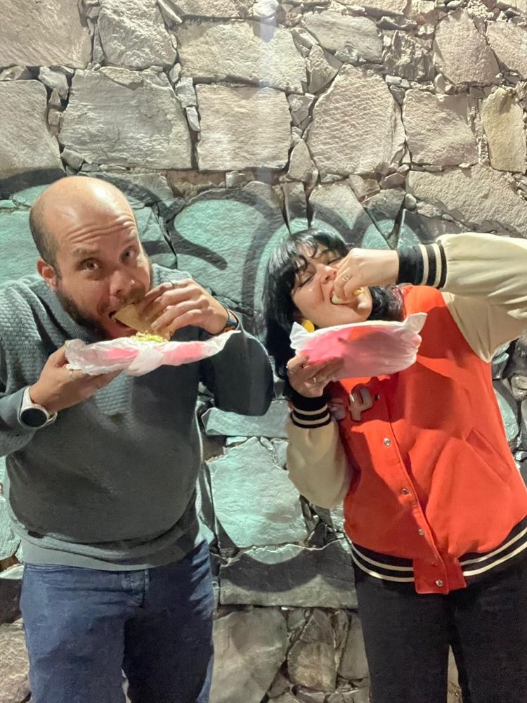 Mario mid-bite, eating tacos with a friend